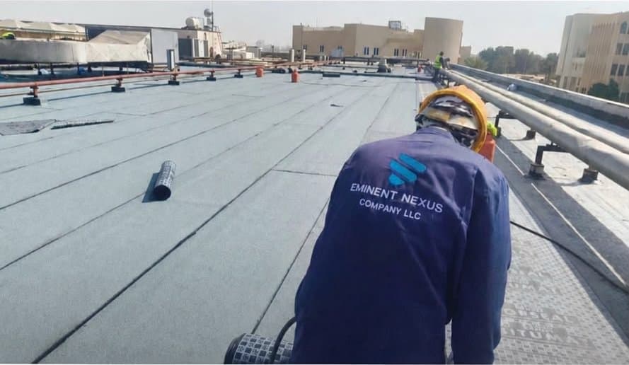 Eminent Nexus technician applying bituminous waterproofing membrane on the Institute of Public Administration roof